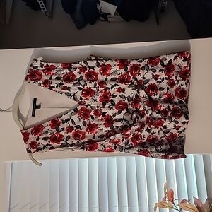 Like New: WHBM sleeveless blouse. White, black, and red roses. Size L.
